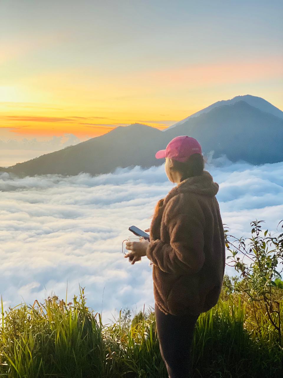 Traveler looking over clouds from Mount Batur